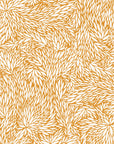 Botanical-inspired wallpaper with an intricate pattern of overlapping leaves in a warm golden hue against a crisp white background.