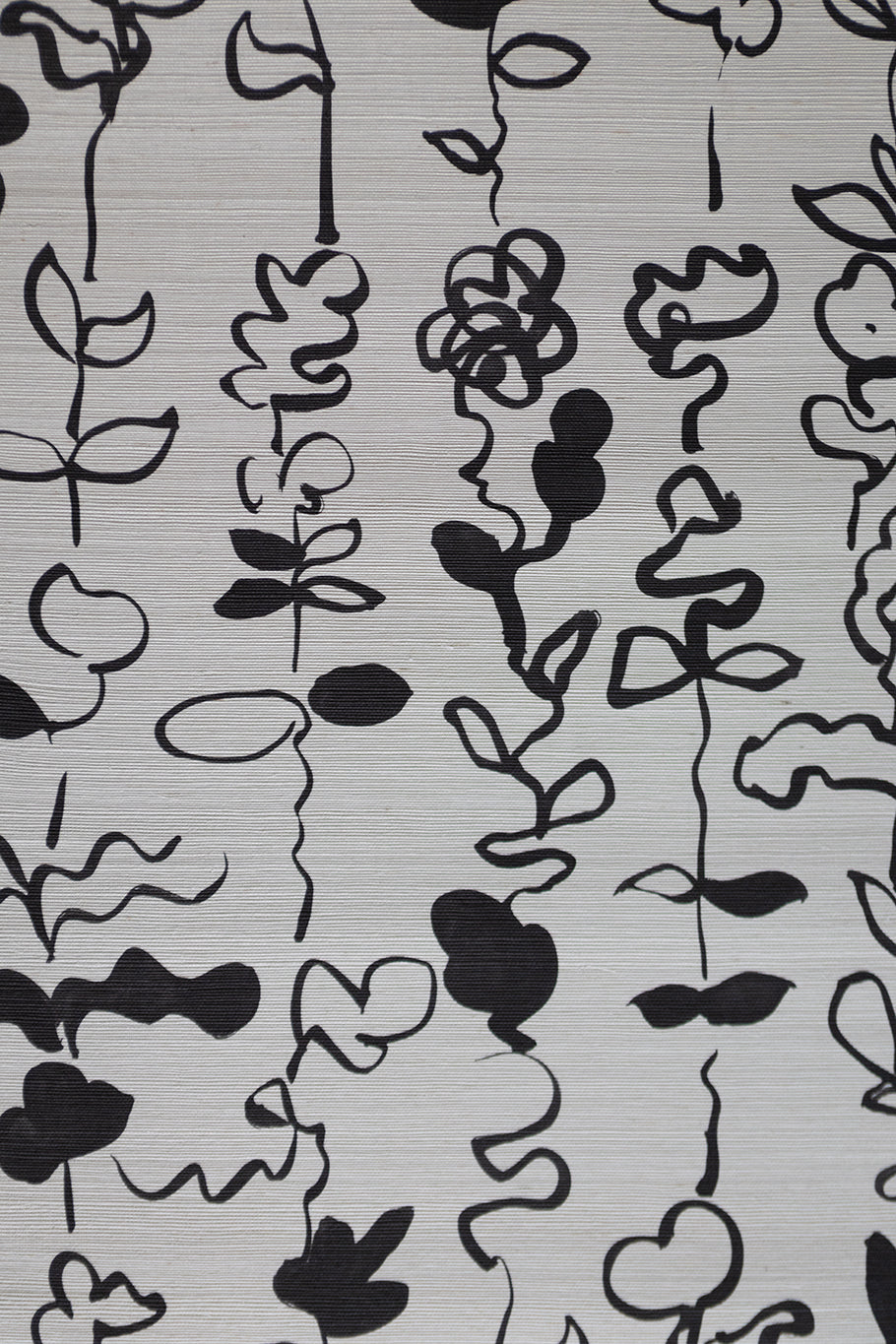 Grasscloth wallpaper with a repeating pattern of abstract black floral stirpe on an off-white textured surface.