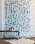 Charming wallpaper with hand-drawn blue bows on a pale blue background, styled with a modern metallic coffee table and a plush white rug.