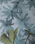 Light gray-blue wallpaper with abstract floral pattern, featuring intricate details; potted green-leaf plant in a terracotta planter in the foreground