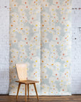 Floral grasscloth wallpaper with a wooden chair and lamp against a white brick wall.