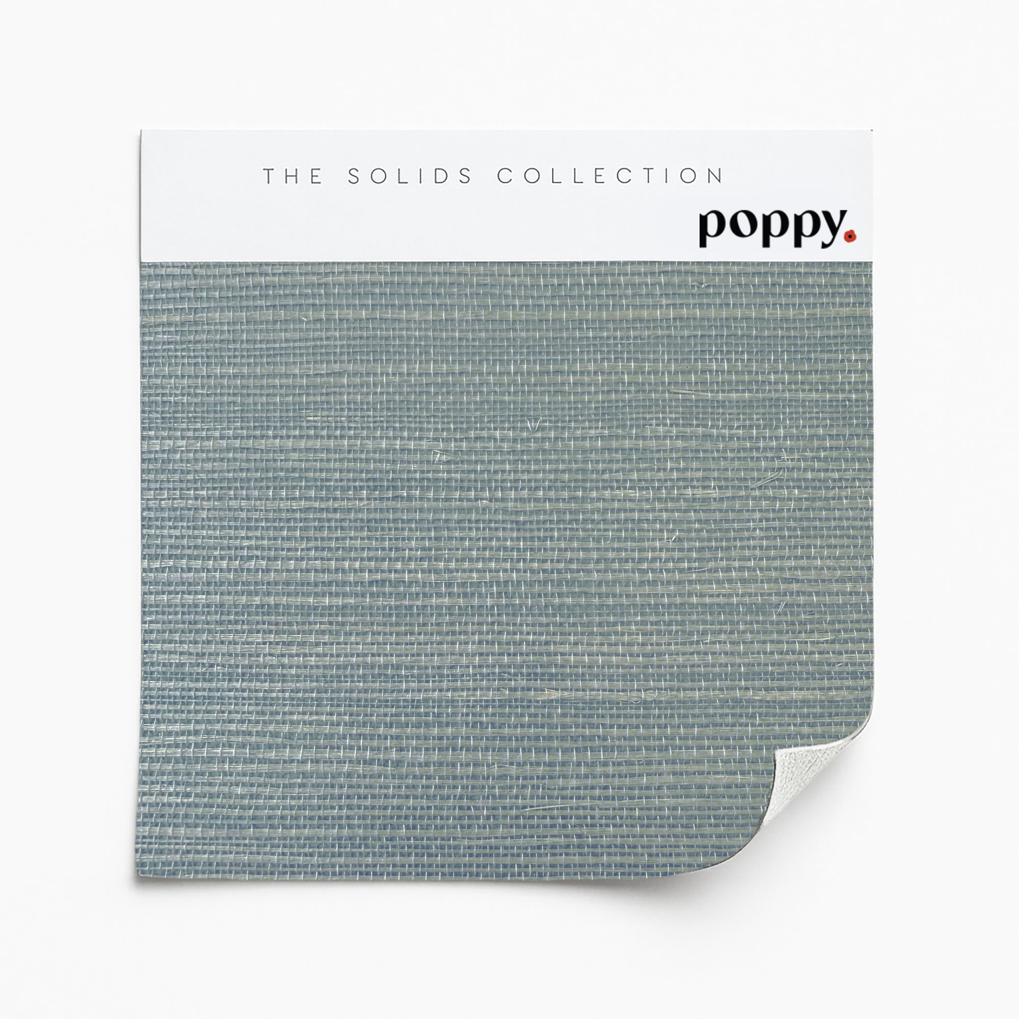 Slate blue grasscloth wallpaper sample featuring a natural woven texture from Poppy Print Studio’s Solids Collection.