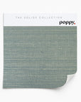 Slate blue grasscloth wallpaper sample featuring a natural woven texture from Poppy Print Studio’s Solids Collection.