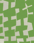 A close-up of geometric-patterned grasscloth wallpaper in vibrant green and off-white, featuring irregularly shaped blocks creating an abstract, modern design.