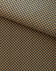 A folded roll of deep brown and black checkered grasscloth wallpaper with a subtle textured finish, giving a classic yet modern aesthetic
