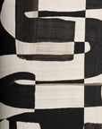 Detailed close-up of black and white grasscloth wallpaper, emphasizing the hand-painted brushstroke effect and natural weave texture.
