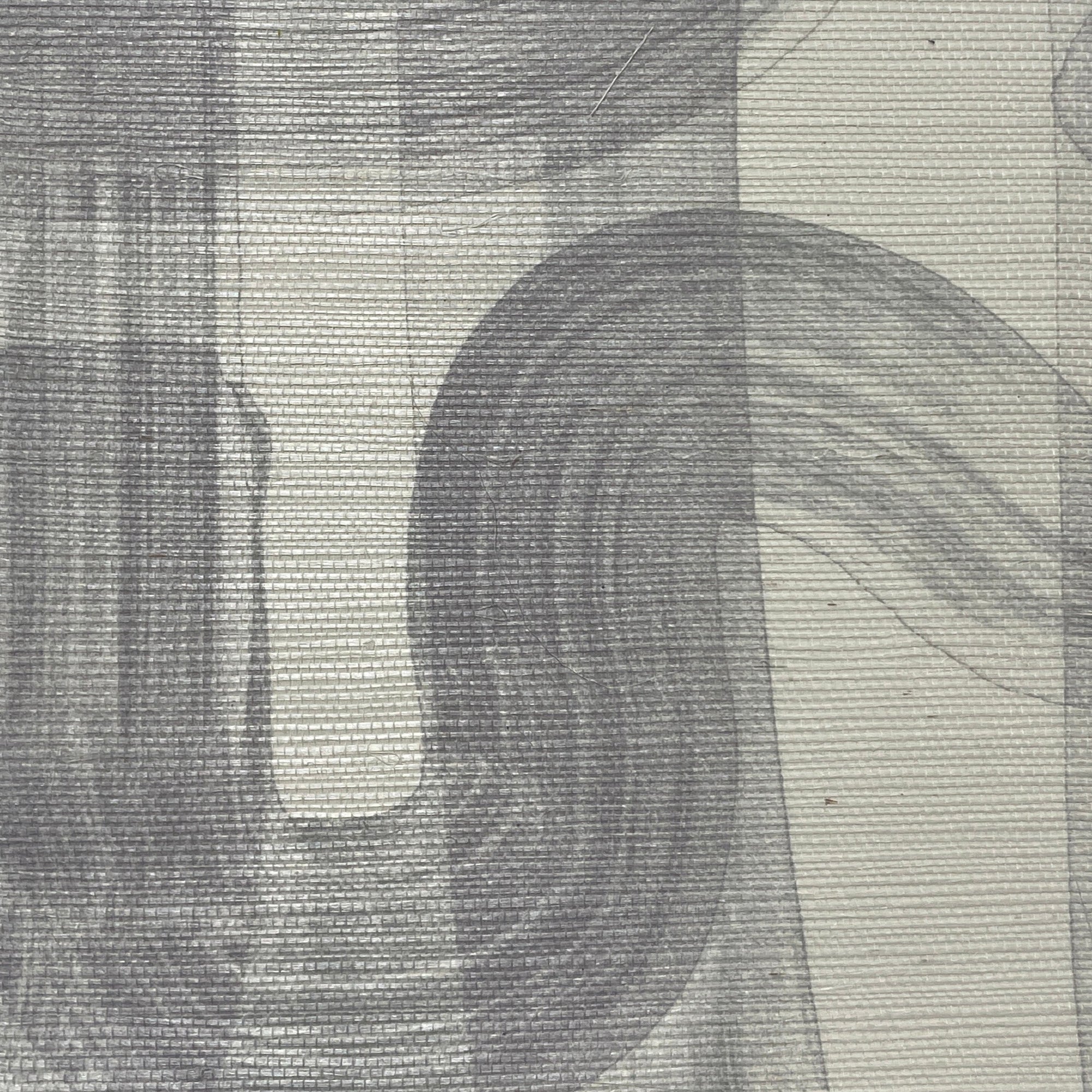 Close-up of gray-toned grasscloth wallpaper, showcasing the soft brushstroke design and textured surface.