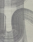 Close-up of gray-toned grasscloth wallpaper, showcasing the soft brushstroke design and textured surface.