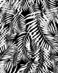 Close-up of black and white tropical palm leaf wallpaper featuring a rippling, wave-like visual texture.