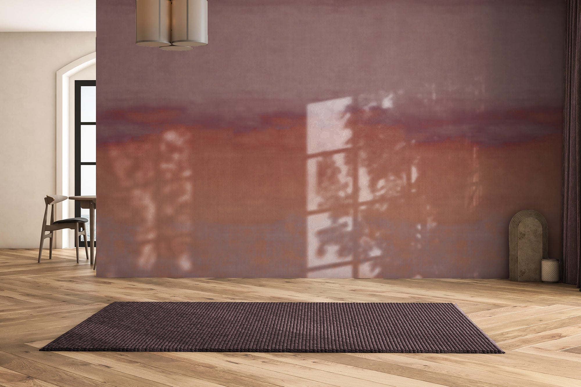 Sunset-inspired wallpaper in rich terracotta and mauve tones with a soft, painted effect, creating a cozy accent wall in a modern living space.