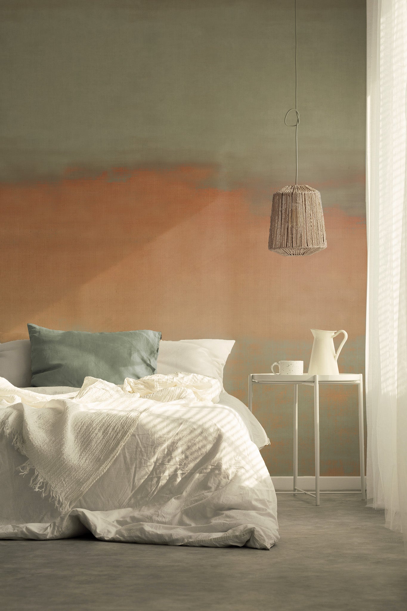 Earthy gradient wallpaper in sage green and warm clay orange tones, styled in a serene bedroom with layered white bedding and soft morning light.