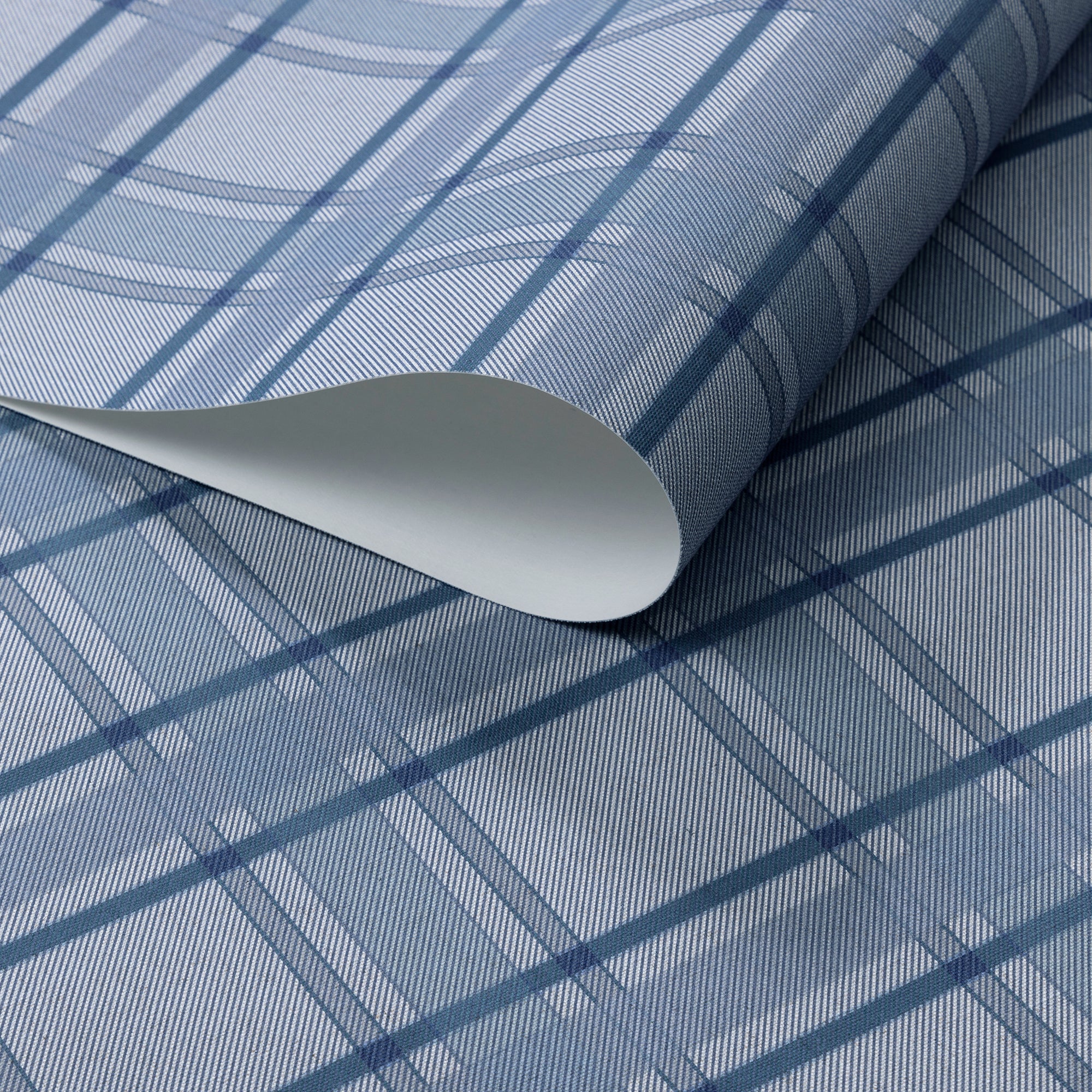 Rolled blue plaid wallpaper with a soft diagonal twill texture, featuring intersecting navy and sky-blue lines for a tailored, textile-inspired look.