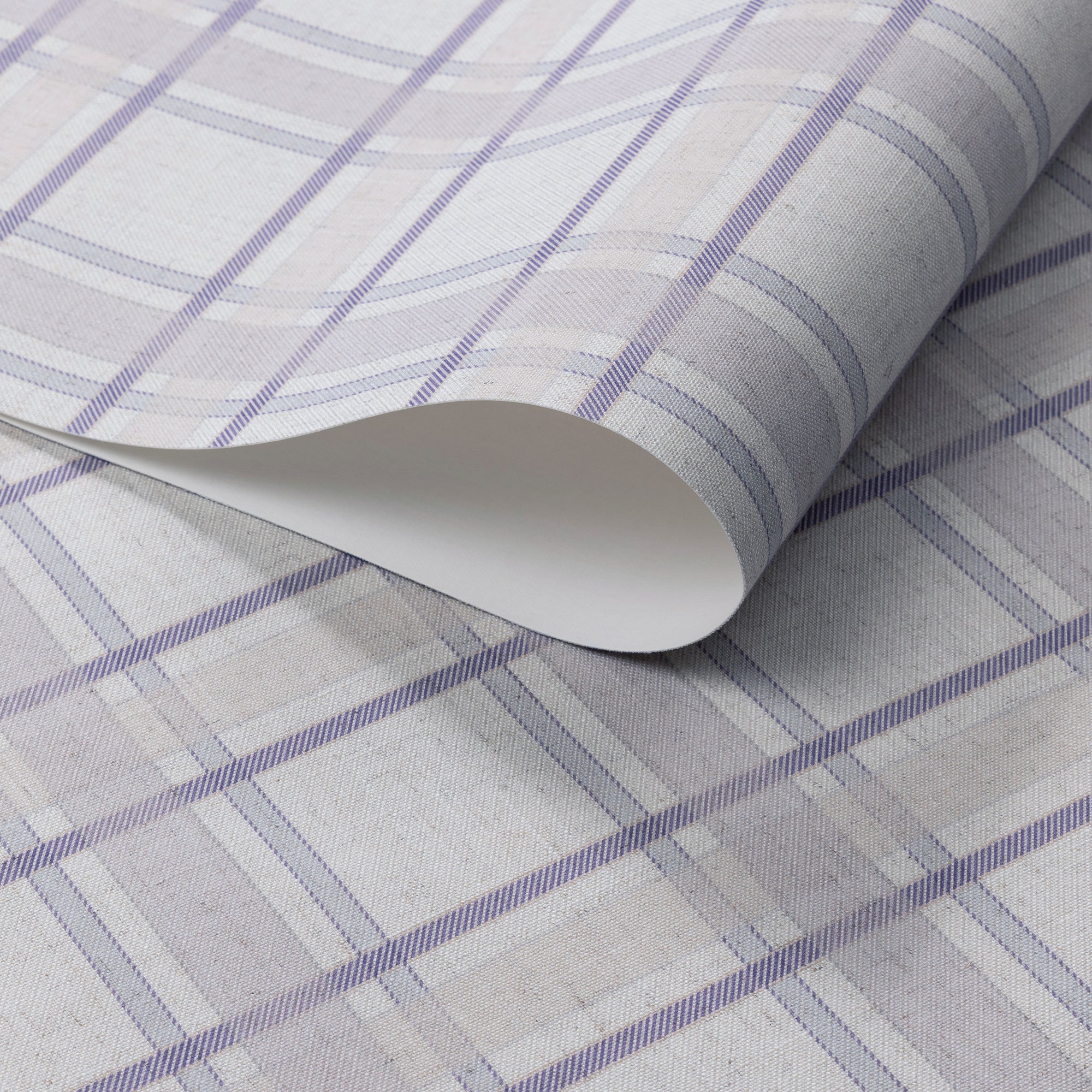 Rolled linen wallpaper featuring a soft lavender plaid pattern with cream and light taupe accents on a subtle woven-texture background.