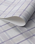 Rolled linen wallpaper featuring a soft lavender plaid pattern with cream and light taupe accents on a subtle woven-texture background.