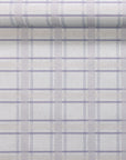 Lavender plaid linen wallpaper partially unrolled to showcase its balanced grid design with cream and taupe tones on a soft-textured base.