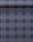 Partially unrolled navy wallpaper with brown and beige plaid grid, highlighting the sharp lines and woven texture of the linen wallpaper.