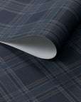 Rolled wallpaper featuring a deep charcoal base with fine plaid lines in muted brown and soft grey, styled with a subtle diagonal twill texture.