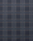 Flat lay of dark plaid linen wallpaper with a grid pattern of thin white, grey, and brown lines on a rich charcoal background.