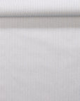 Rolled wallpaper with subtle vertical stripes in pale blue and cream tones, showcasing a fabric-inspired, linen-like finish.