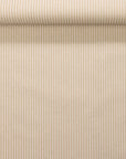 Rolled wallpaper displaying soft beige vertical stripes on a cream background, woven linen fabric