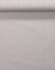 Rolled linen wallpaper showing narrow dark grey and off-white stripes.
