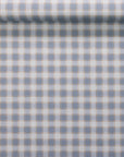 Rolled wallpaper showcasing the vintage plaid check pattern in muted blue and beige on a fabric linen texture.