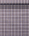 Rolled wallpaper sample displaying a vintage plaid check in dusty lavender and taupe with a refined linen texture.