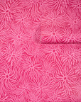 Bold pink wallpaper with swirling, wavy magenta lines radiating from circular
centers, partially unrolled to display its energetic design.