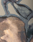 Close-up of a silk wallpaper featuring a watercolor-inspired botanical design in shades of blue, beige, and gray, with a hand-painted effect.