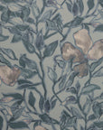 Full view of a silk wallpaper with a detailed floral and leafy pattern in muted blue tones on a soft grayish-blue background, creating a painterly effect.