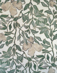 Silk wallpaper with a botanical design in green and beige tones, featuring hand-painted leaves and flowers on a light, neutral background.