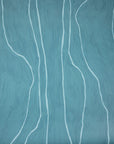 Close-up of teal wallpaper featuring soft white vertical lines, adding a modern and calming touch.