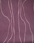 Close-up of plum wallpaper featuring flowing pale pink vertical lines, adding a warm and artistic feel.