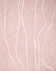 Close-up of blush wallpaper featuring delicate white vertical lines, adding a subtle and modern artistic touch.