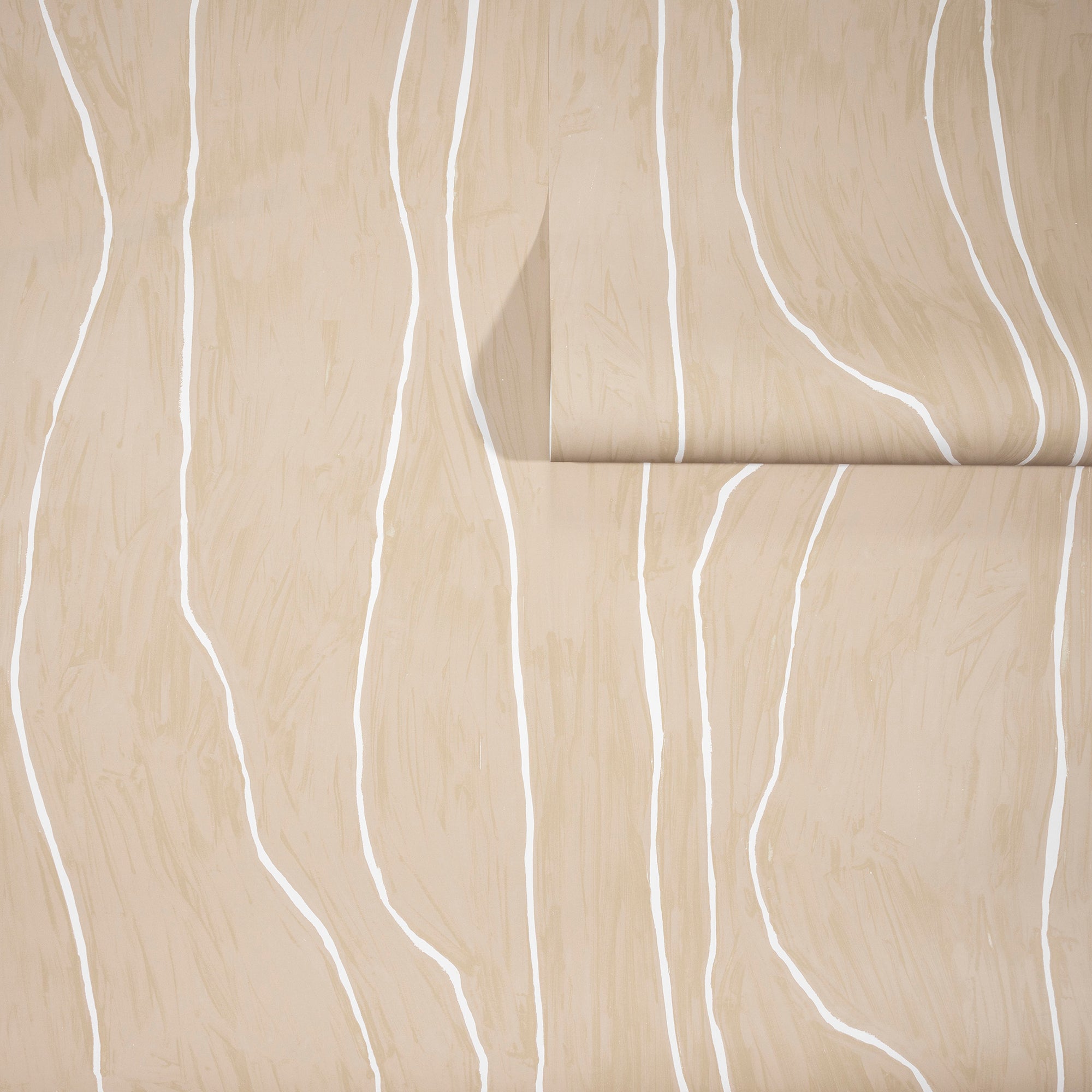 Warm beige wallpaper with abstract white wavy vertical lines, partially unrolled to showcase its natural and earthy aesthetic.