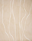 Close-up of beige wallpaper featuring flowing white vertical lines, creating a serene and contemporary look.