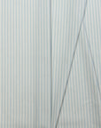 Light blue and cream striped linen fabric by the yard, folded showing drape and weight