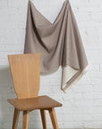 Tan and cream striped linen fabric by the yard, draped to show pattern and scale