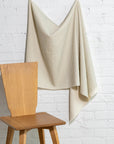 Sage green and cream striped linen fabric by the yard, draped to show pattern and scale