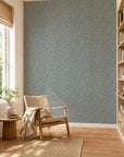 Blue-gray leafy floral commercial wallcovering installed in a sunlit reading nook