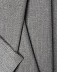 Gray herringbone outdoor fabric by the yard, folded showing drape and weight