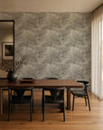 Gray and ivory hand-sketched foliage wallpaper installed in a dining room