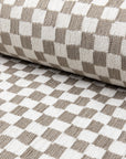 Light gray and cream checkerboard jacquard upholstery fabric by the yard, rolled bolt view