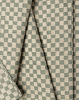 Olive green and cream checkerboard jacquard upholstery fabric by the yard, folded showing drape and weight