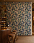 Blue watercolor floral on cream wallpaper installed behind a wine bar