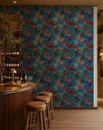 Jewel-tone floral on bright blue wallpaper installed behind a wine bar