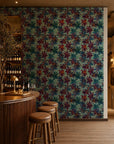 Burgundy and navy floral on teal wallpaper installed behind a wine bar