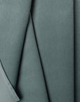Green velveteen upholstery fabric by the yard, folded showing drape and weight