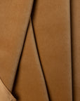 Brown velveteen upholstery fabric by the yard, folded showing drape and weight