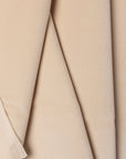 Beige velveteen upholstery fabric by the yard, folded showing drape and weight